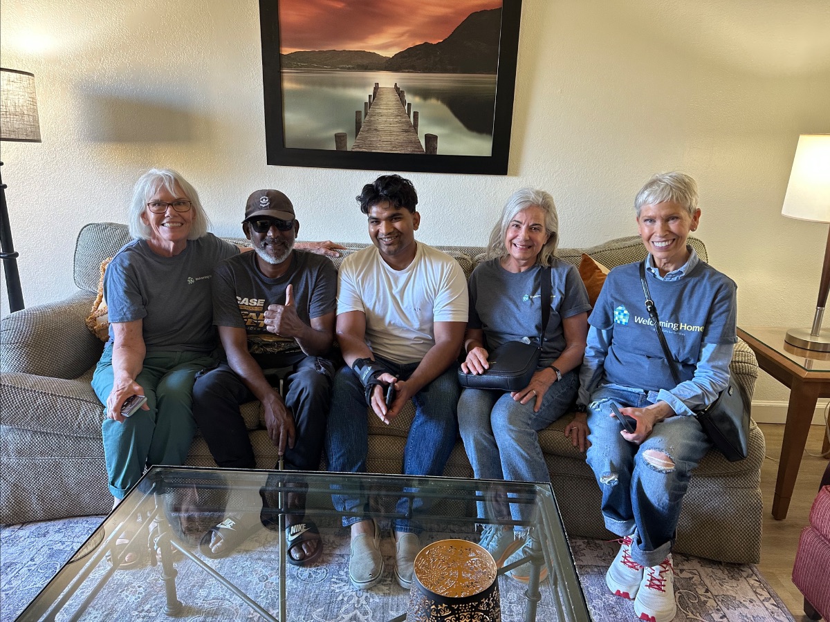 Volunteers furnishing a home together for a family in need